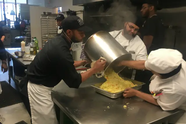 Karim Ramsay helping prepare a family meal at Brownsville Community Culinary Center.